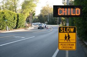 SafeXing™ Advanced Warning Sign installed at a golf cart crossing path.